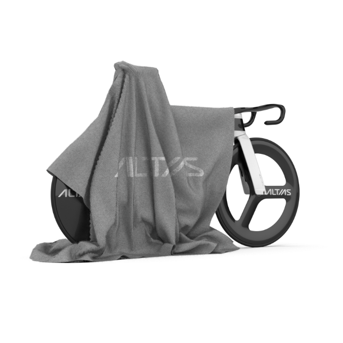 Bicycle partially covered by a gray cloth on a white background